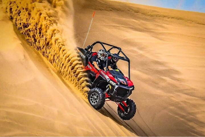 Experience the exhilaration of a dune buggy ride across stunning sand dunes followed by a magical sunset and authentic Arabian hospitality at a luxurious desert camp.